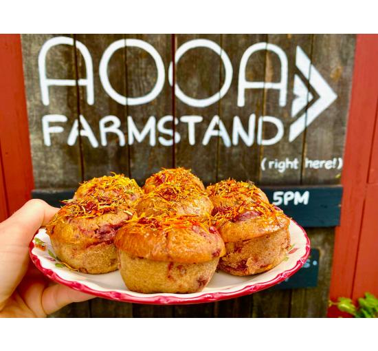 The AOOA farmstand logo on barn with an image of tea cakes