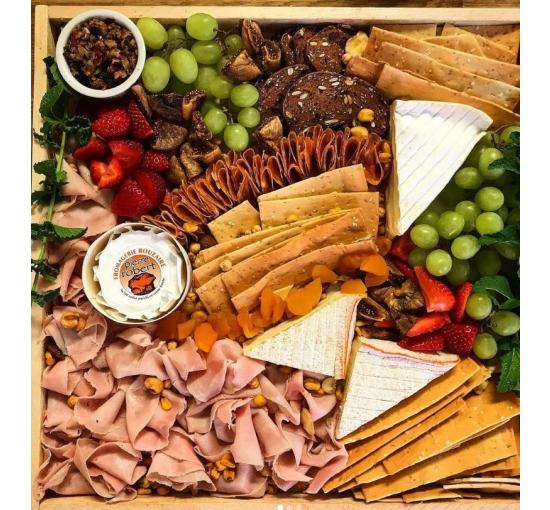 meats and cheeses on a board