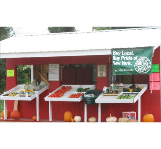 picture of farm store set against a red barn