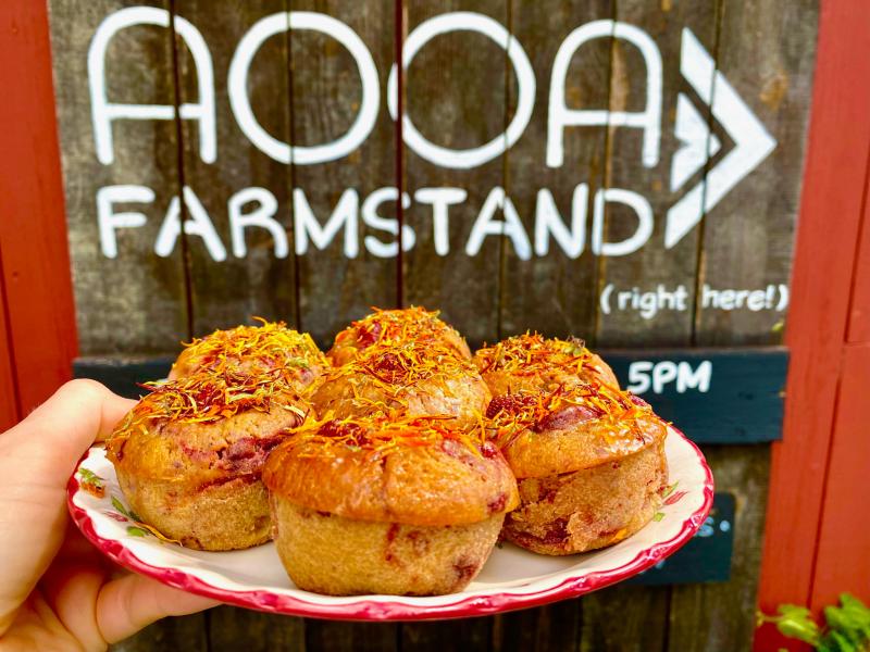 The AOOA farmstand logo on barn with an image of tea cakes