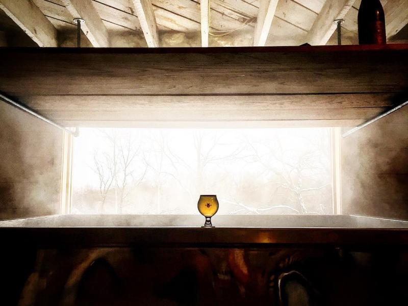 image of taproom with the sun setting in
