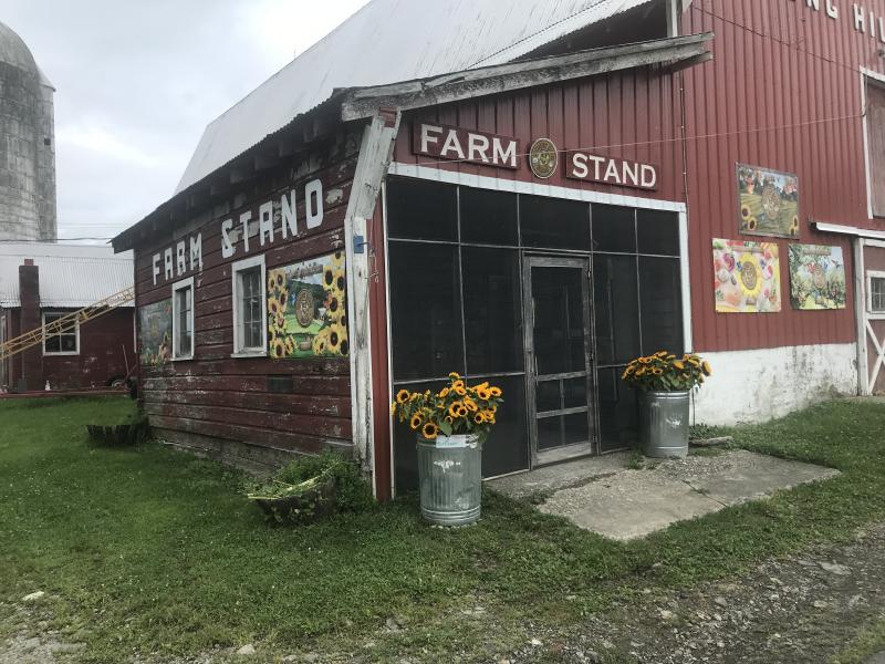 image of farm stand red barn with images on farm