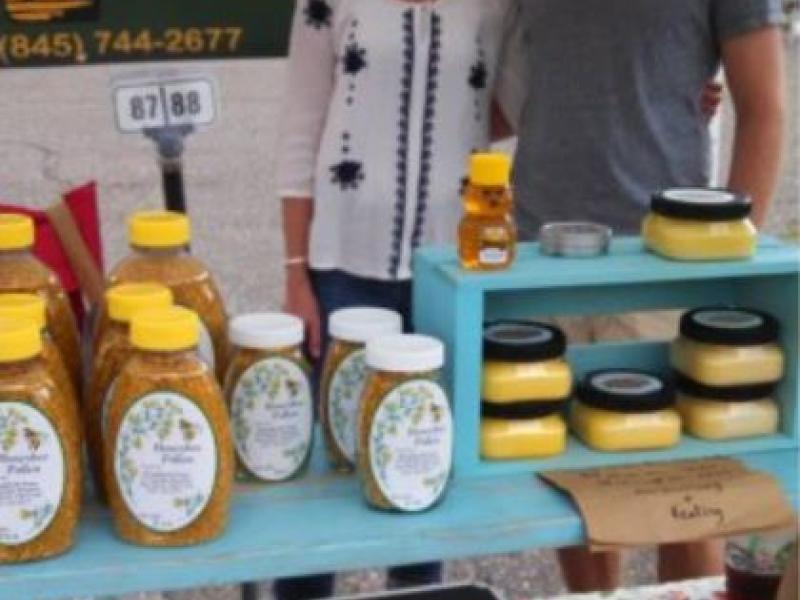 vendor event set up with owners and honey on tables
