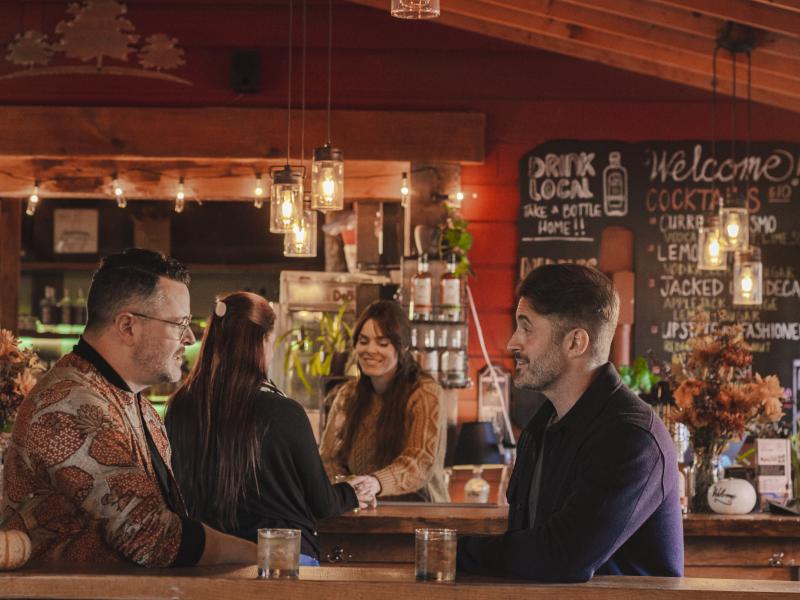 inside the distillery with bartenders serving customers