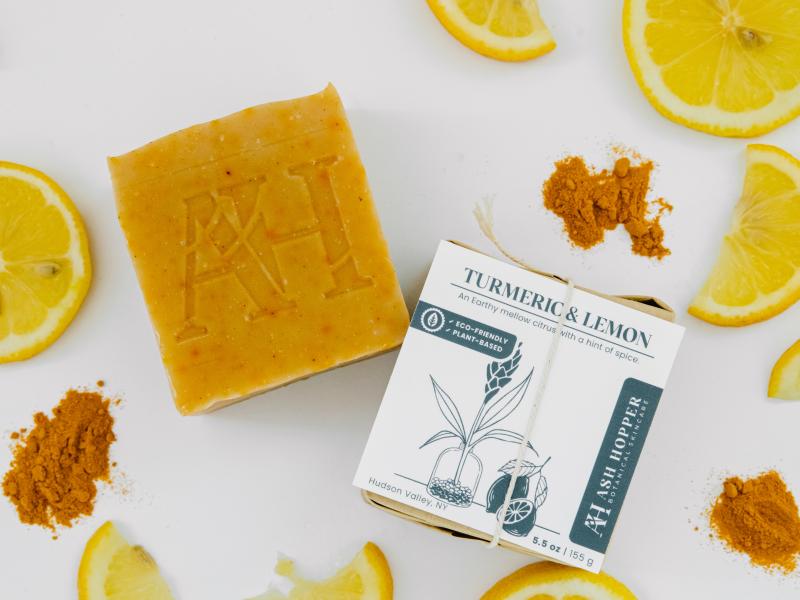 Turmeric Lemon soap surrounded by lemons and turmeric.