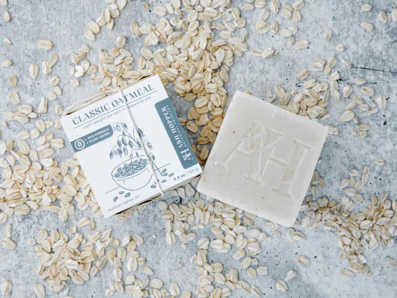 classic oatmeal soap packaged with oatmeal spread all over table
