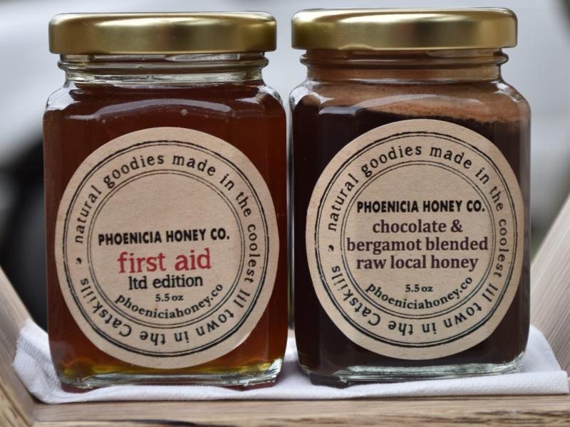 Two jars of Phoenicia Honey: First Aid and Chocolate and Bergamot Blended