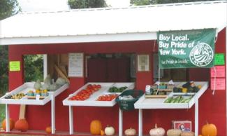 picture of farm store set against a red barn